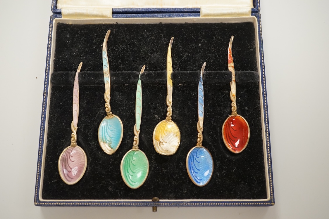 A cased set of six George VI silver teaspoons, James Dixon & Sons, Sheffield, 1948, a cased set of six silver and polychrome enamel coffee spoons and a cased single silver spoon.